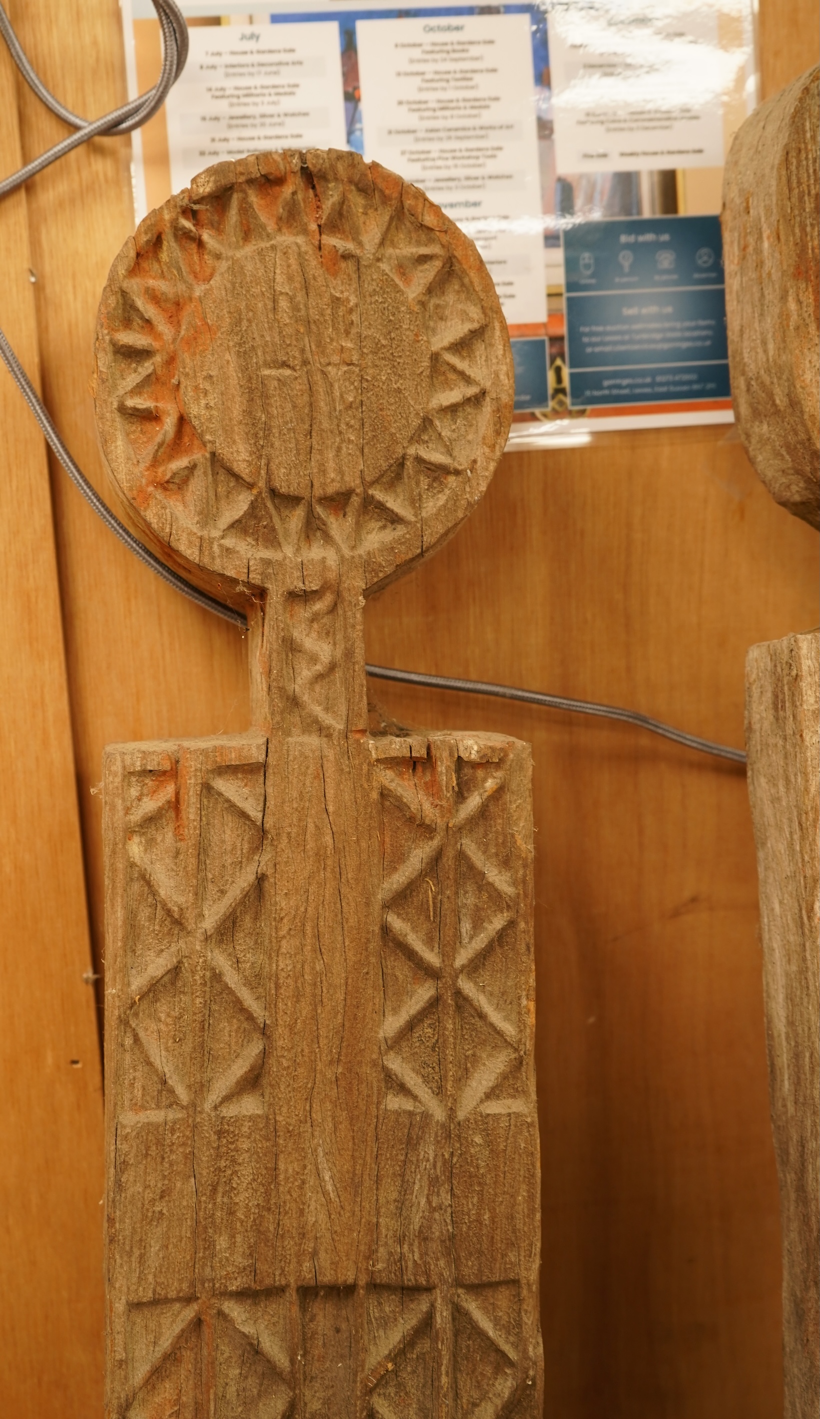 Two African carved wood ancestor figures, tallest 171cm, with two European carved mask capitals